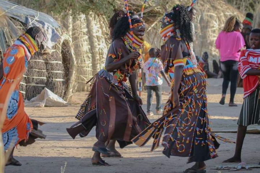 Experience Kenya’s blend of eco-conscious luxury and authentic cultural immersion—from Maasai Mara conservancies to Swahili coast retreats. Tourists enjoying a cultural dance with Maasai warriors at sunset